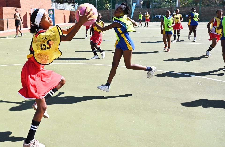 School learners playing netball during a community safety tournament in Bellville promoting youth engagement and crime prevention