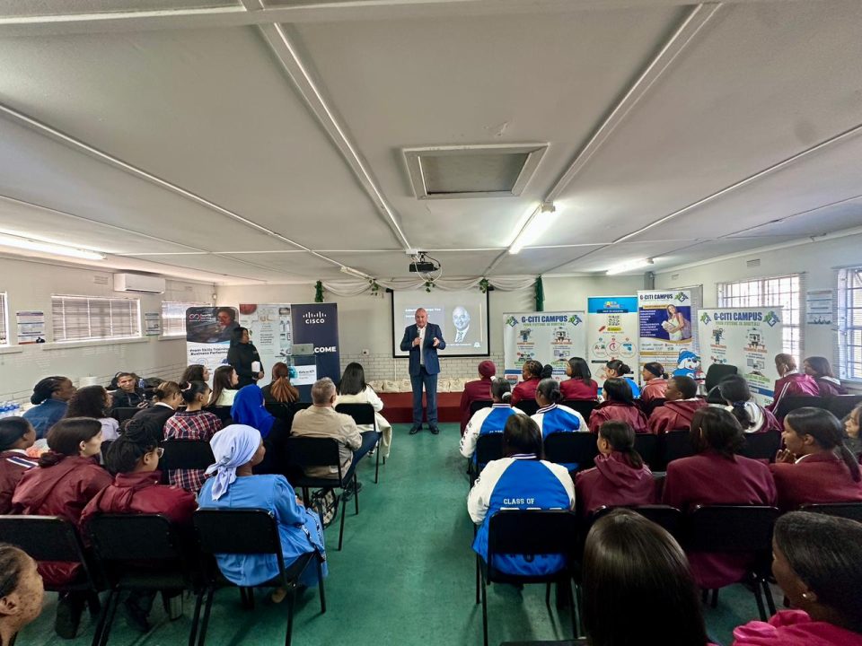 Learners attend an ICT career guidance session in a classroom, listening to a speaker presenting opportunities in the technology sector.