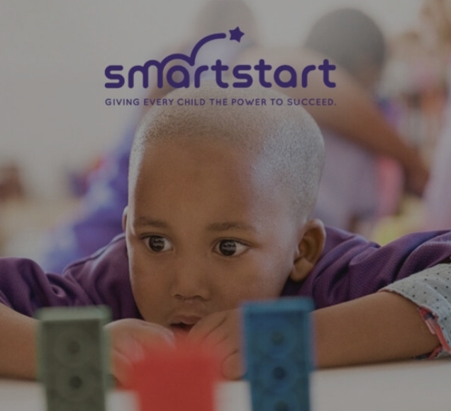 Young child learning with colourful blocks in early childhood development classroom, SmartStart programme South Africa