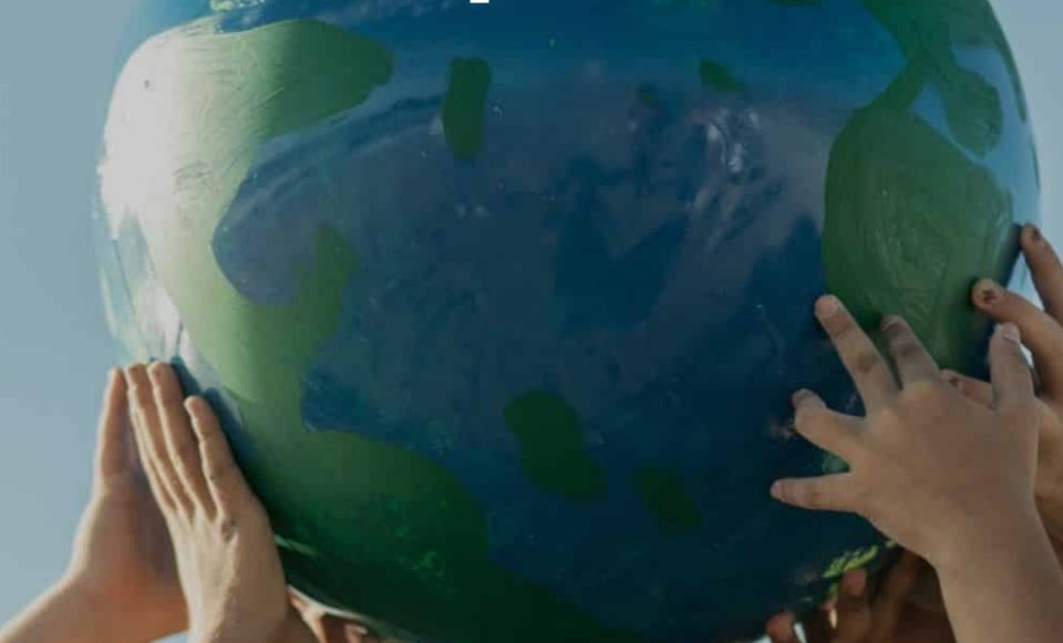 Hands holding a globe symbolising collective responsibility for protecting the planet on Earth Day