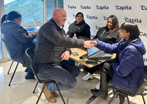 Job interview taking place at a contact centre recruitment event where a candidate shakes hands with an employer in the BPO sector in Cape Town