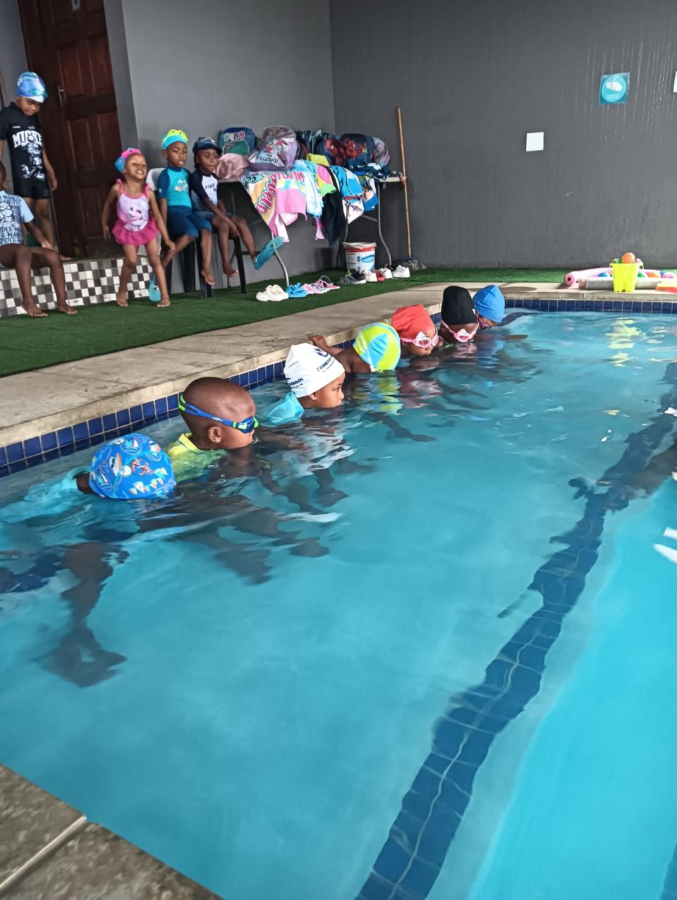 Children participate in a swimming lesson at Soweto Swim School’s indoor facility as part of a programme focused on water safety and youth development.