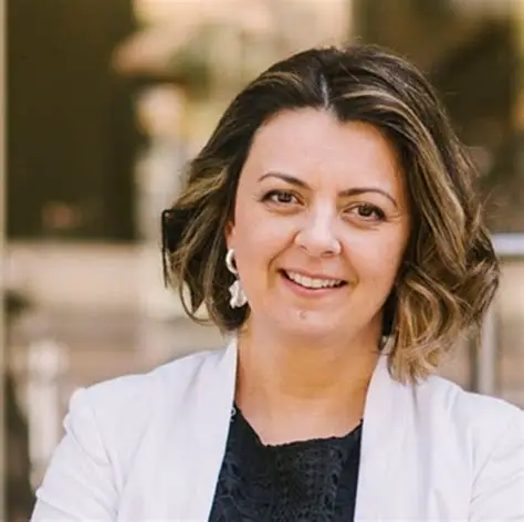 Professor Ana Adi smiles during a professional portrait used for a University of Johannesburg social impact workshop announcement.