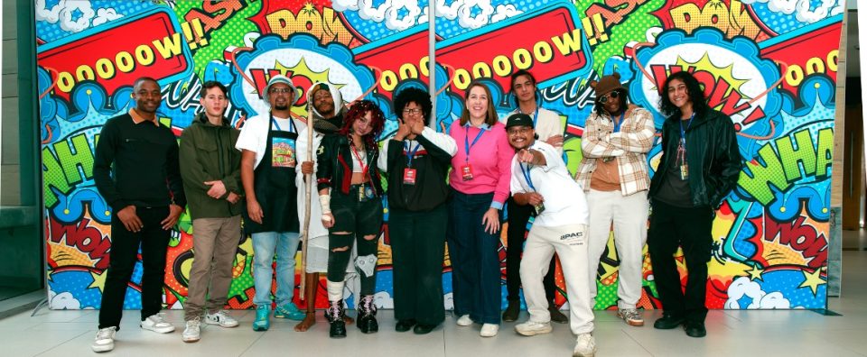 Emerging artists posing together at Comic Con 2026 Artist Alley exhibition