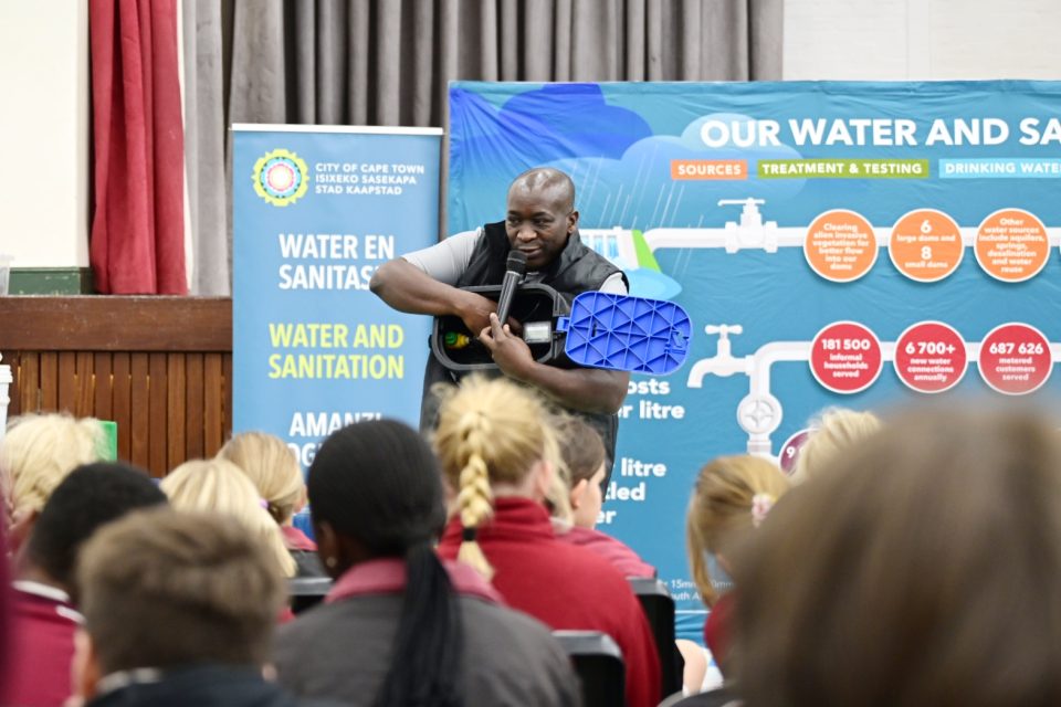 A City of Cape Town water educator demonstrates a water meter to learners during an interactive water conservation awareness session at Kommetjie Primary School.