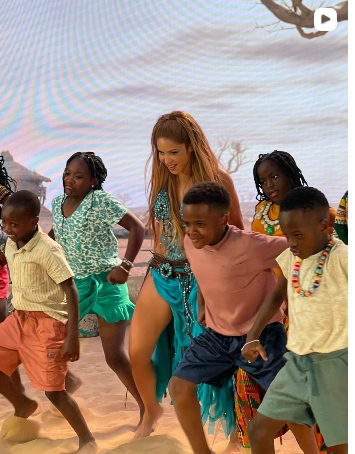 Shakira dances with children from Uganda's Ghetto Kids during a rehearsal or promotional performance ahead of their FIFA World Cup collaboration.