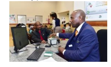 A Home Affairs official assists a citizen at a service counter as part of efforts to improve access to government services through digital transformation.