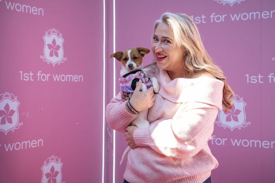 Jacqui Martheze, General Manager of Woodrock Animal Rescue, holds a rescued puppy at the First for Women partnership event promoting pet adoption and animal welfare in South Africa.