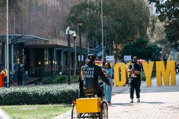 A cyclist rides through Johannesburg's car-free Main Street during a Jozi My Jozi event promoting safer, more accessible public spaces for pedestrians and cyclists.