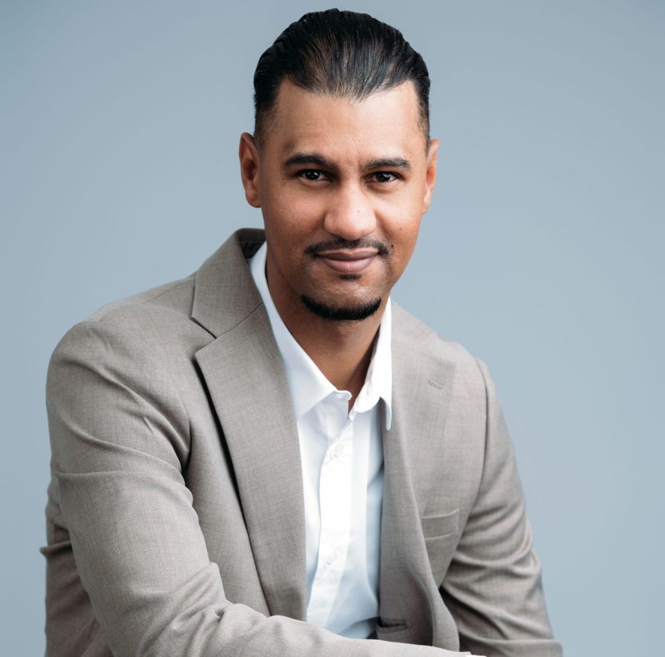 Ashif Black, Country Representative for inDrive South Africa, poses for a professional portrait wearing a light grey suit and white shirt.