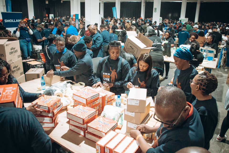 Hundreds of volunteers pack food parcels during FoodForward SA's Mandela Day initiative, working together to prepare nutritious meals for vulnerable communities across South Africa.