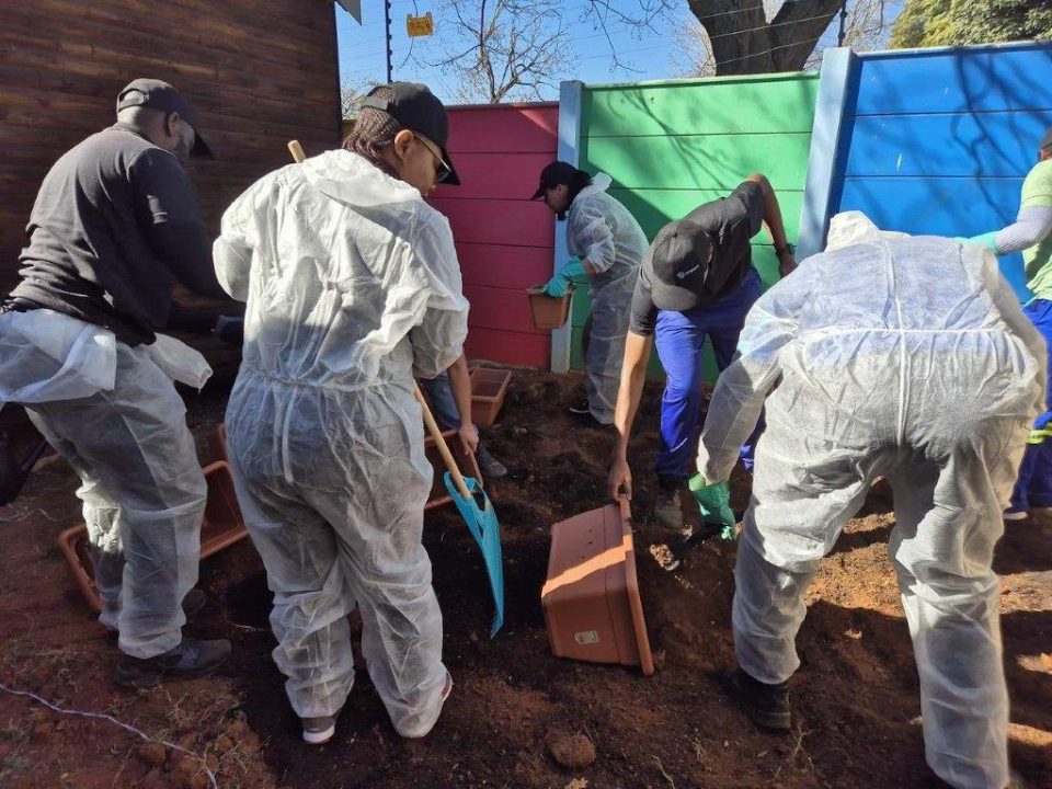 Empact Group and Feedem volunteers prepare and plant a vegetable garden at a community facility during a Mandela Day initiative, helping create a sustainable source of fresh produce.