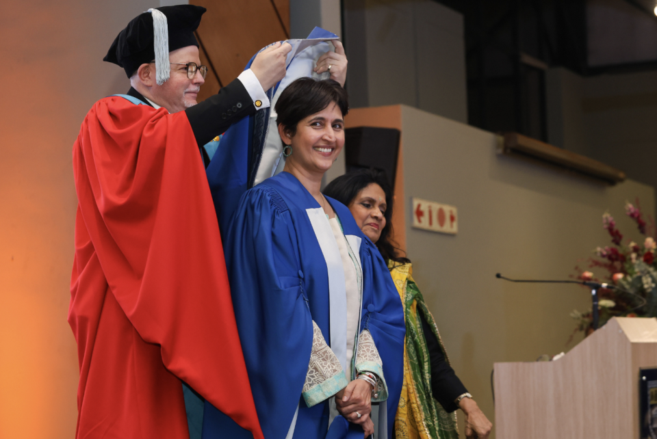Honorary doctorate recipient smiles during a University of the Western Cape conferral ceremony.