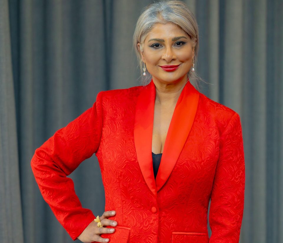 Katie Mohamed, Founder of W-Suite, pictured in a red suit.