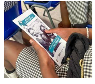 Young woman reading cervical cancer and HPV awareness information as part of a women’s health education initiative.