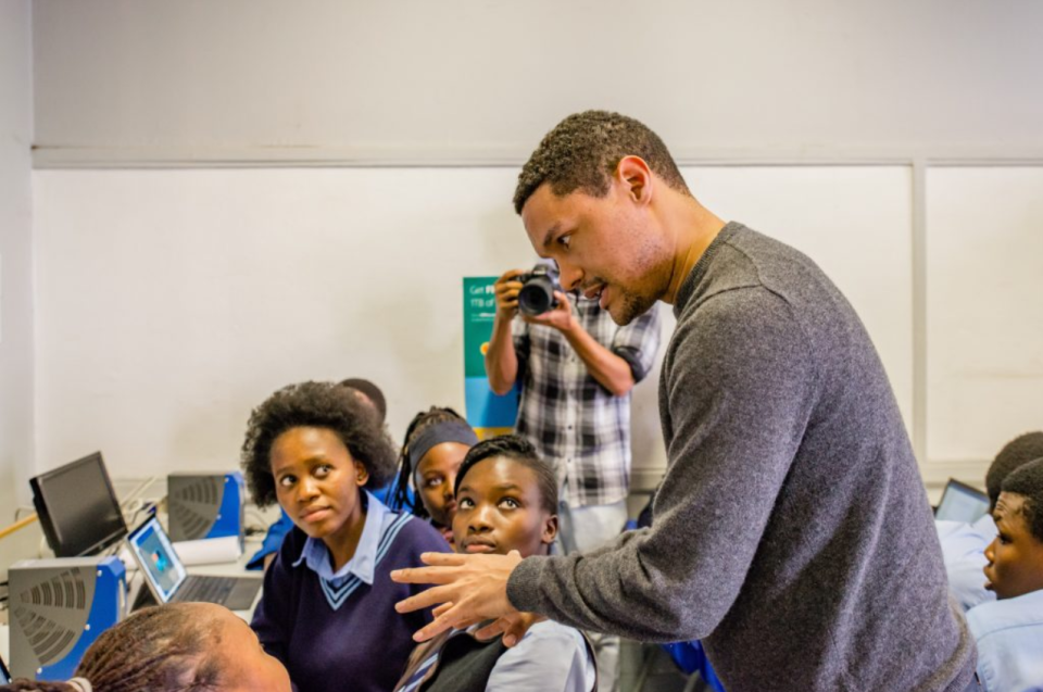 Trevor Noah engages with learners during an education programme supporting learning and skills development in South Africa.