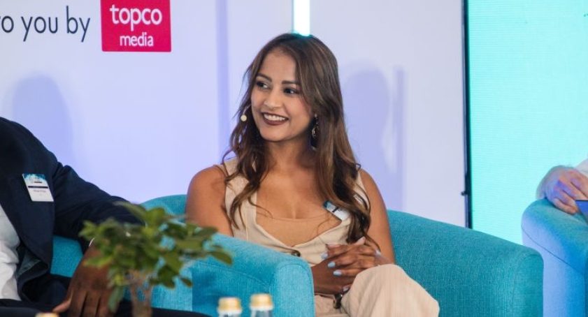 Talita Boodhram speaking during a panel discussion on stage.