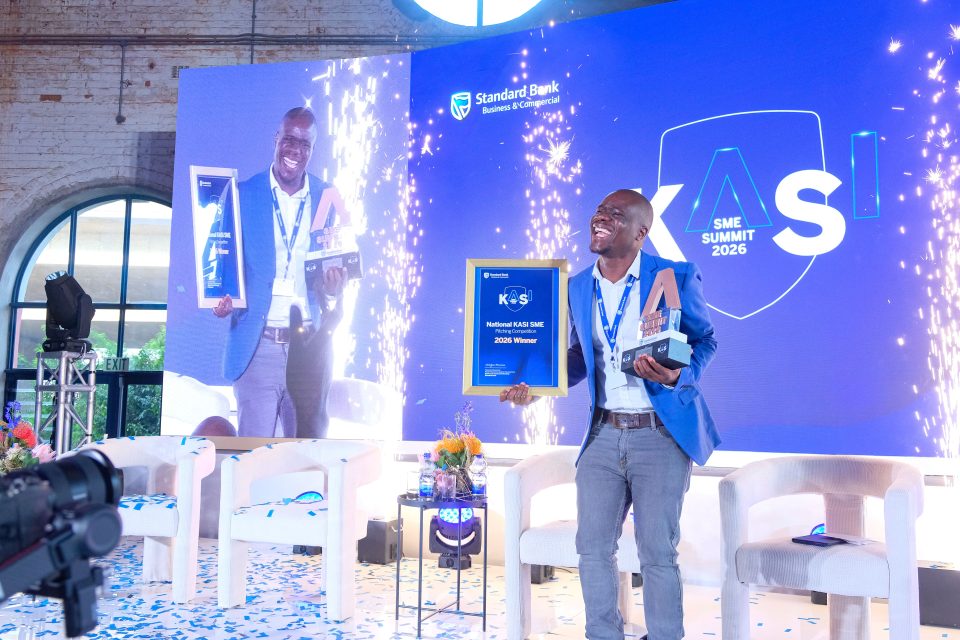 Winner of the 2026 Standard Bank Kasi SME National Pitch Challenge celebrates on stage while holding his award.