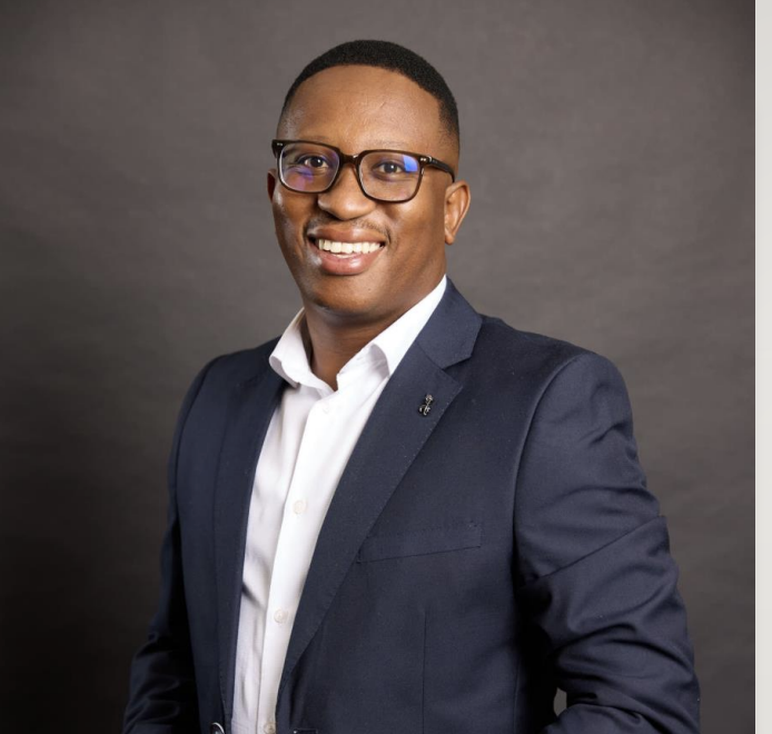 Kabelo Motheane, Regional Head for Gold Business at FNB Business, pictured in a navy suit and glasses.