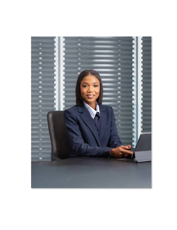 Woman executive seated at a desk with a laptop, representing leadership supporting youth technical skills development and future artisan careers in South Africa.