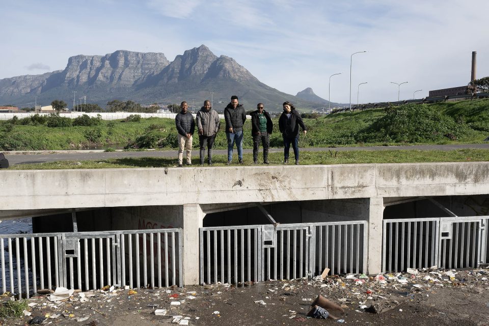 Waste interceptor installed in Cape Town’s Black River near Langa, with Table Mountain visible in the background.