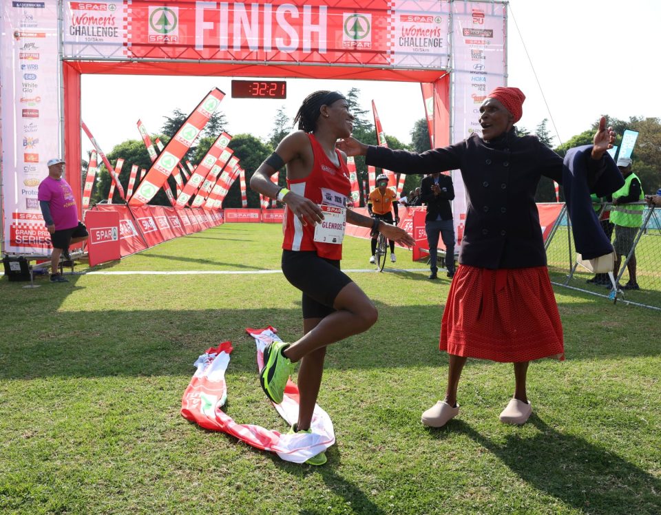 Jozi SPAR Women’s Challenge winner celebrates with her grandmother after crossing the finish line at Marks Park Sports Club in Johannesburg.