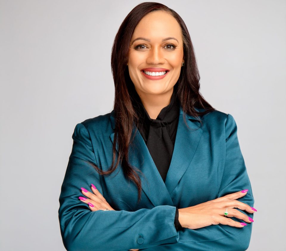 Lytania Johnson, CEO of FNB, pictured in a teal blazer, leading the bank’s efforts to expand financial inclusion and affordable homeownership.