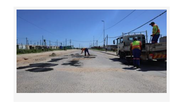 Road maintenance workers repair potholes on a Nelson Mandela Bay road as part of the municipality’s Fill Up the Bay campaign.